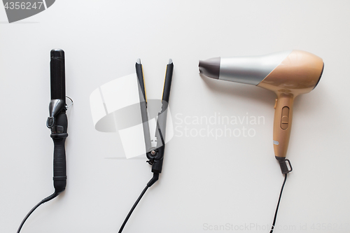 Image of hairdryer, hot styler and curling iron or tongs