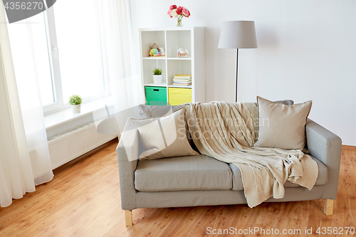 Image of sofa with cushions at cozy home living room