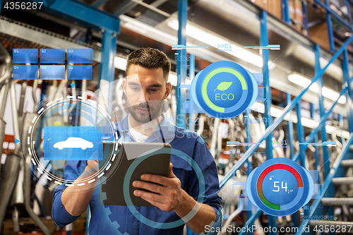 Image of auto mechanic or smith with tablet pc at workshop