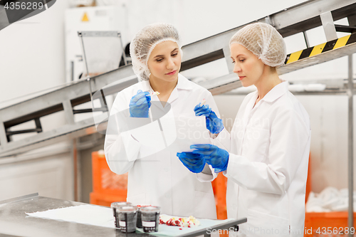 Image of women technologists tasting ice cream at factory