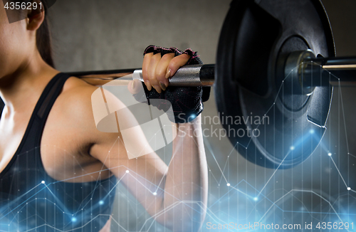 Image of close up of woman with barbell in gym