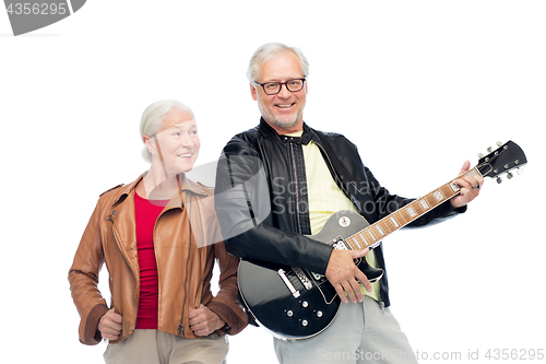 Image of happy senior couple with electric guitar