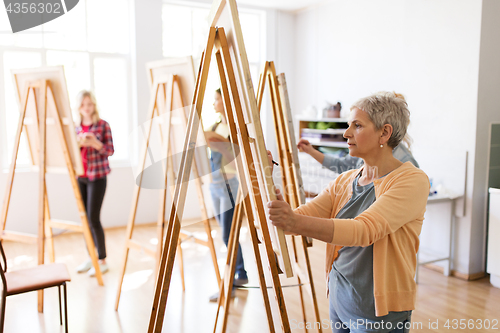 Image of artist with easel and pencil drawing at art school