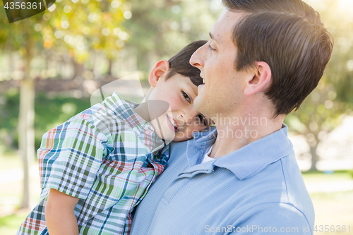 Image of Happy Caucasian Father and Son Playing Together in the Park.