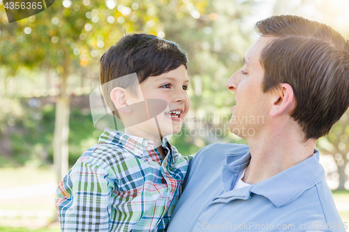 Image of Happy Caucasian Father and Son Playing Together in the Park.