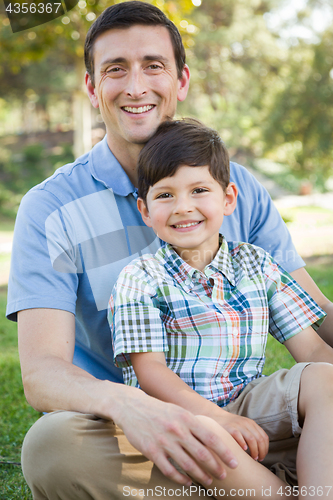 Image of Mixed Race Father and Son Playing Together in the Park.