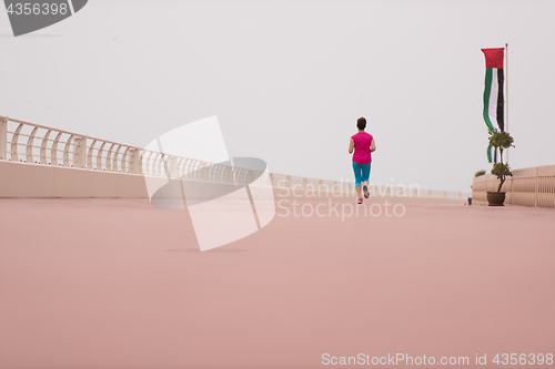 Image of woman busy running on the promenade