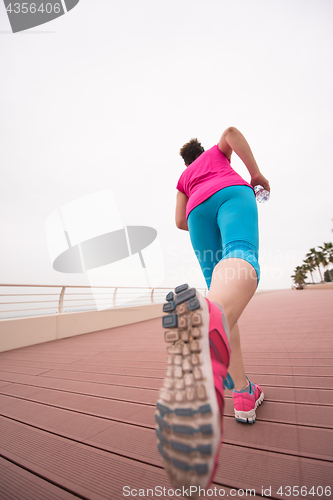 Image of woman busy running on the promenade