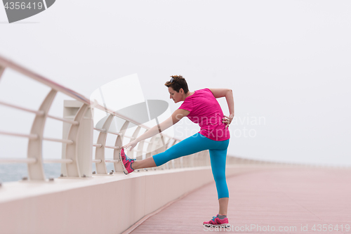 Image of woman stretching and warming up on the promenade