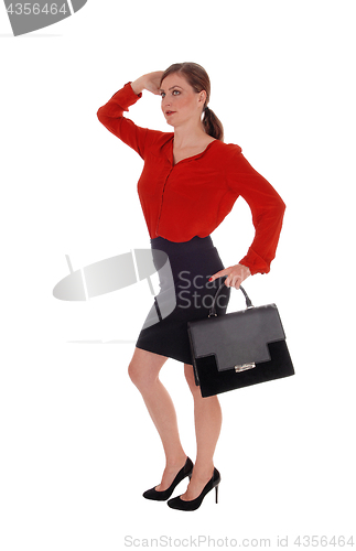 Image of Business woman walking with black purse