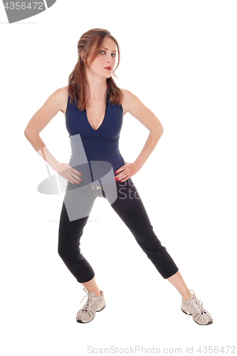 Image of Exercising woman with her hands on hip
