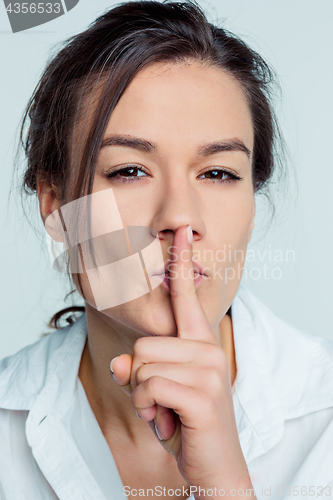 Image of Portrait of young woman with shocked facial expression