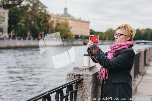 Image of Woman taking shots on waterfront