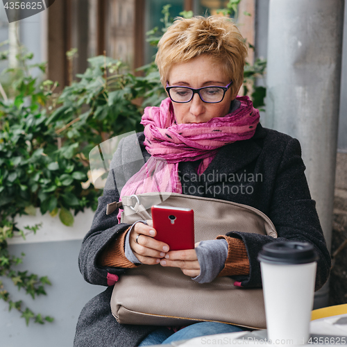 Image of Adult woman surfing phone