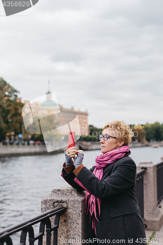 Image of Woman taking shots on waterfront