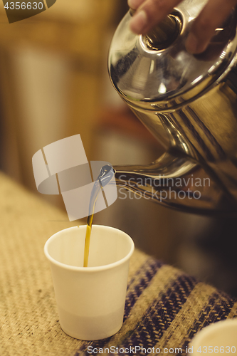Image of Tea pouring in cup