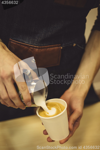 Image of Bartender pouring coffee to cup