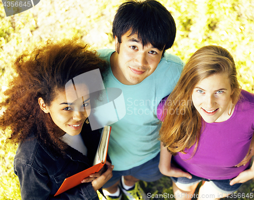 Image of cute group of teenages at the building of university with books huggings, diversity nations