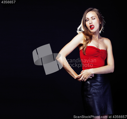 Image of young pretty lady in dress posing sexy on black background