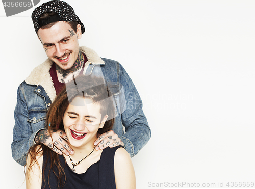 Image of young couple together. guy with tattoo, girlfriend wearing dreadlocks