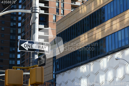 Image of ONE WAY road sign points left on New York street