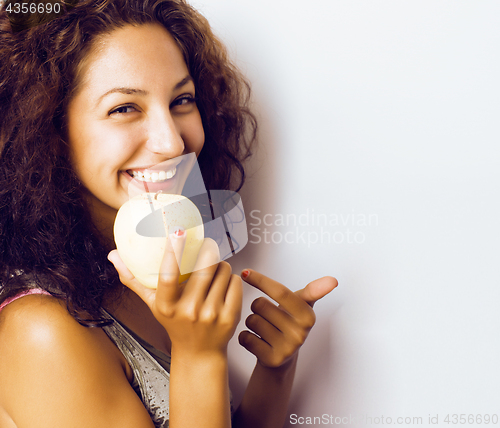 Image of pretty young real tenage girl eating apple close up smiling