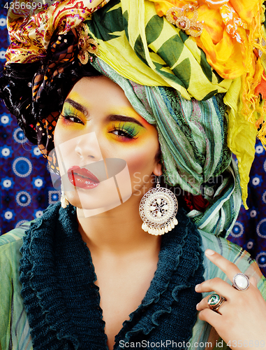 Image of beauty bright woman with creative make up, many shawls on head l