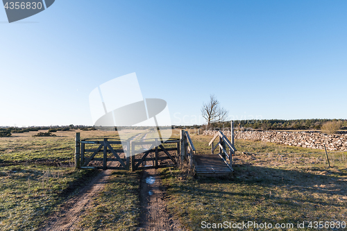 Image of Old gate into a great plain landscape