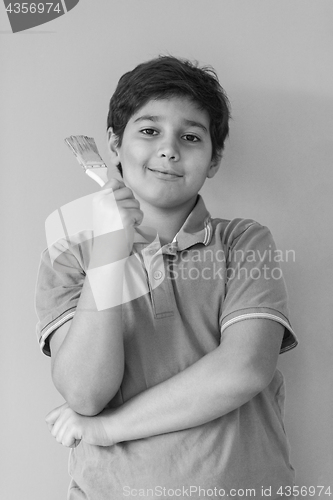 Image of Portrait of a happy young boy painter