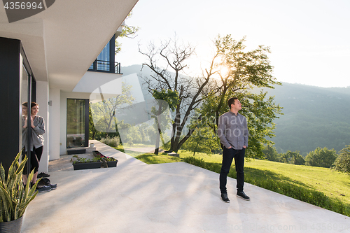 Image of man in front of his luxury home villa