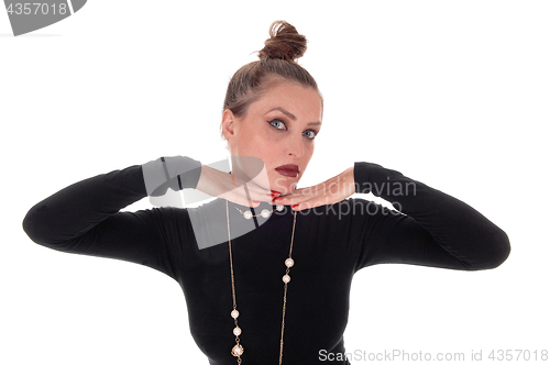 Image of Beautiful young woman with her hand under her chin