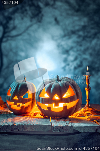 Image of Halloween pumpkins on blue background