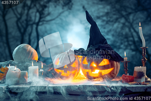 Image of Halloween pumpkins on blue background