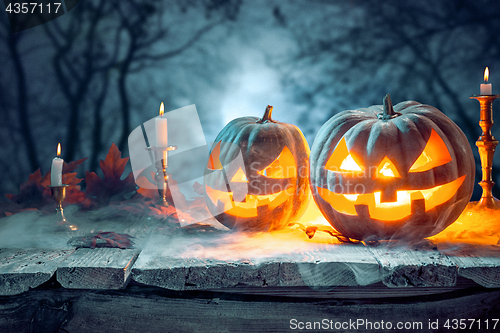 Image of Halloween pumpkins on blue background