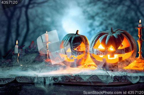 Image of Halloween pumpkins on blue background