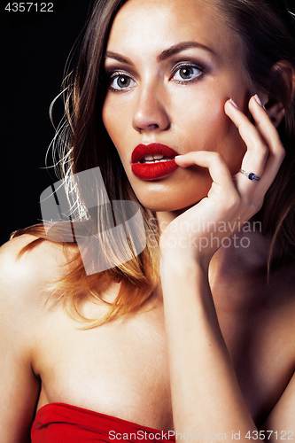 Image of young pretty lady in dress posing sexy on black background