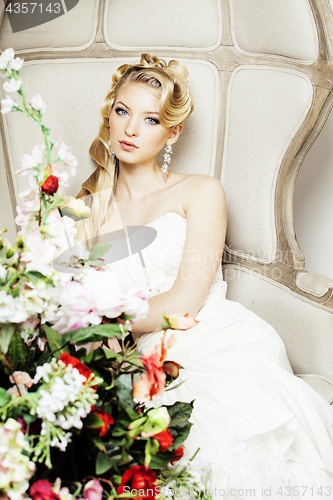 Image of beauty young bride alone in luxury vintage interior with a lot of flowers close up, bridal style