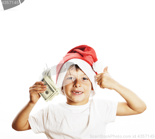 Image of little cute boy in santas red hat isolated with cash american dollars