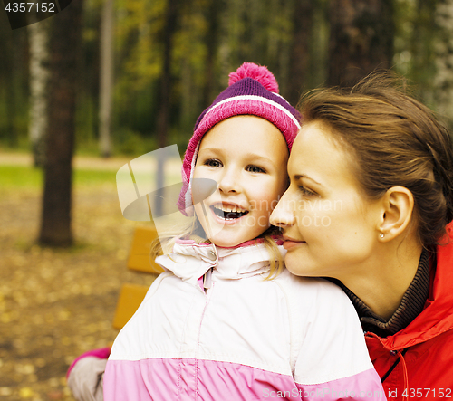 Image of portrait of happy family mother with daughter in park