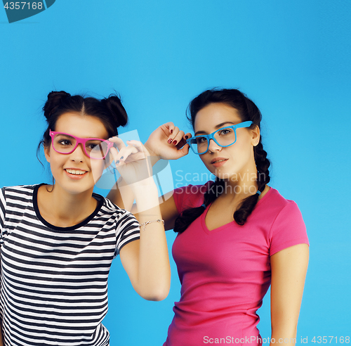 Image of best friends teenage school girls together having fun, posing emotional on blue background, besties happy smiling, lifestyle people concept 