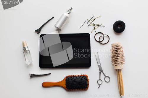 Image of tablet pc, scissors, brushes and other hair tools