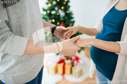 Image of close up of man and pregnant woman at christmas