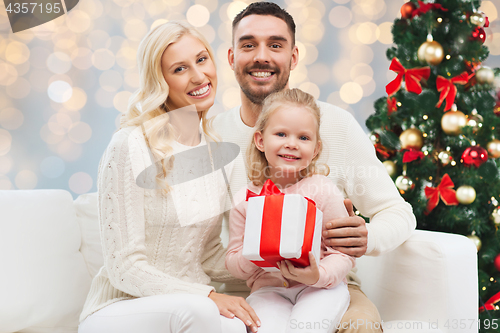 Image of happy family with christmas gift