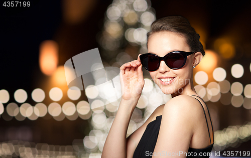 Image of beautiful woman in black sunglasses at christmas