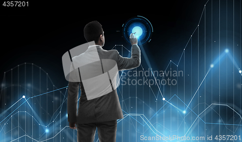 Image of businessman working with virtual chart projection