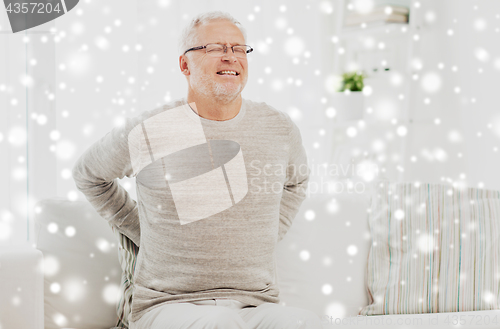 Image of unhappy senior man suffering from backache at home