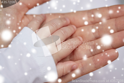 Image of close up of mother and newborn baby hands