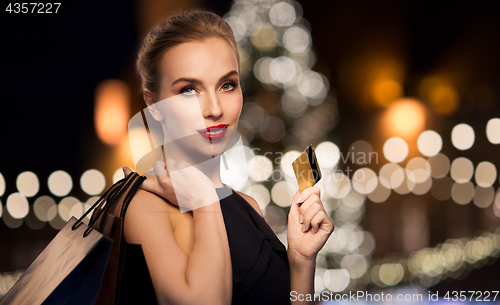 Image of woman with credit card and shopping bags