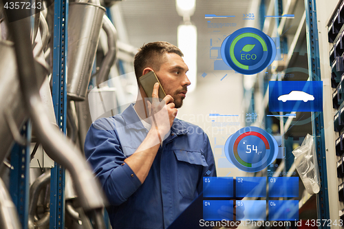 Image of auto mechanic with clipboard at car workshop