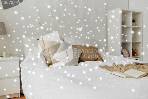 Image of bedroom with bed and christmas garland at home